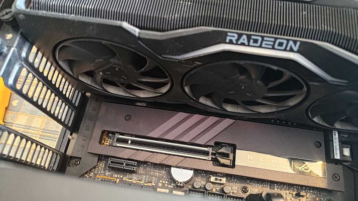 AMD RX 7900 XTX installed beside motherboard