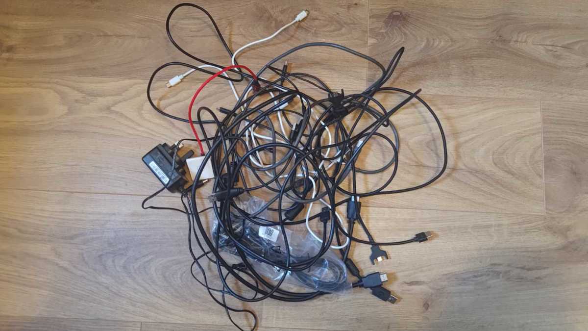Messy bundle of USB-C cables on a wooden floor