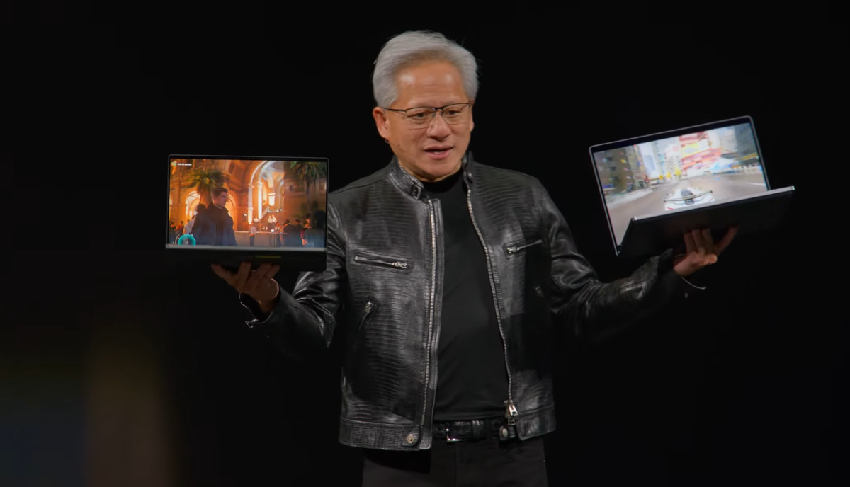 Nvidia Jensen Huang holds up RTX Spark laptops