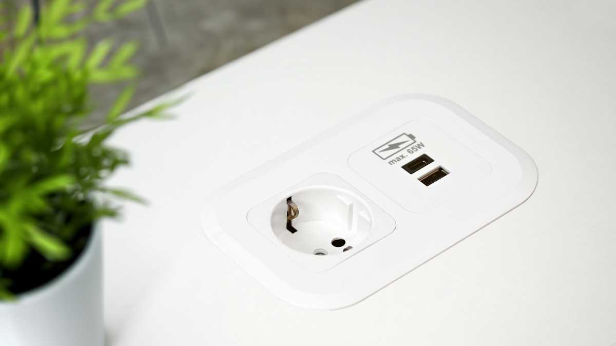Charging ports embedded in a desk