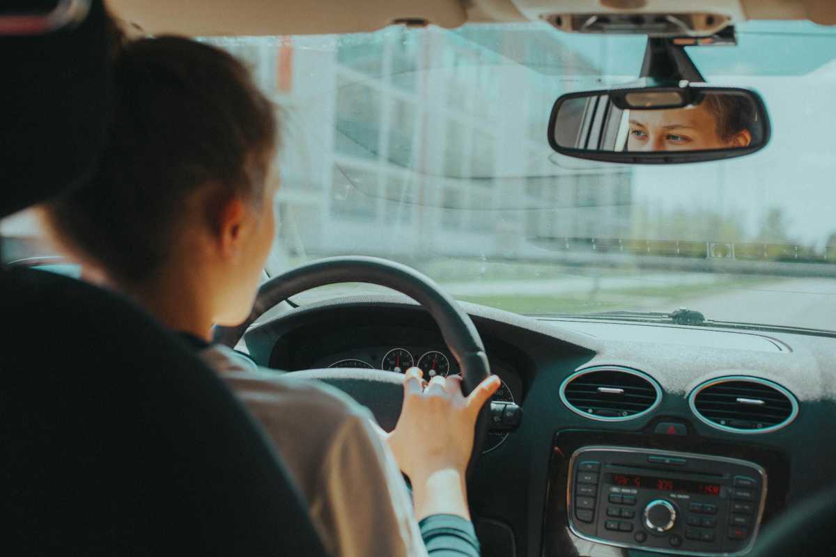 A person in the driver's seat in a car