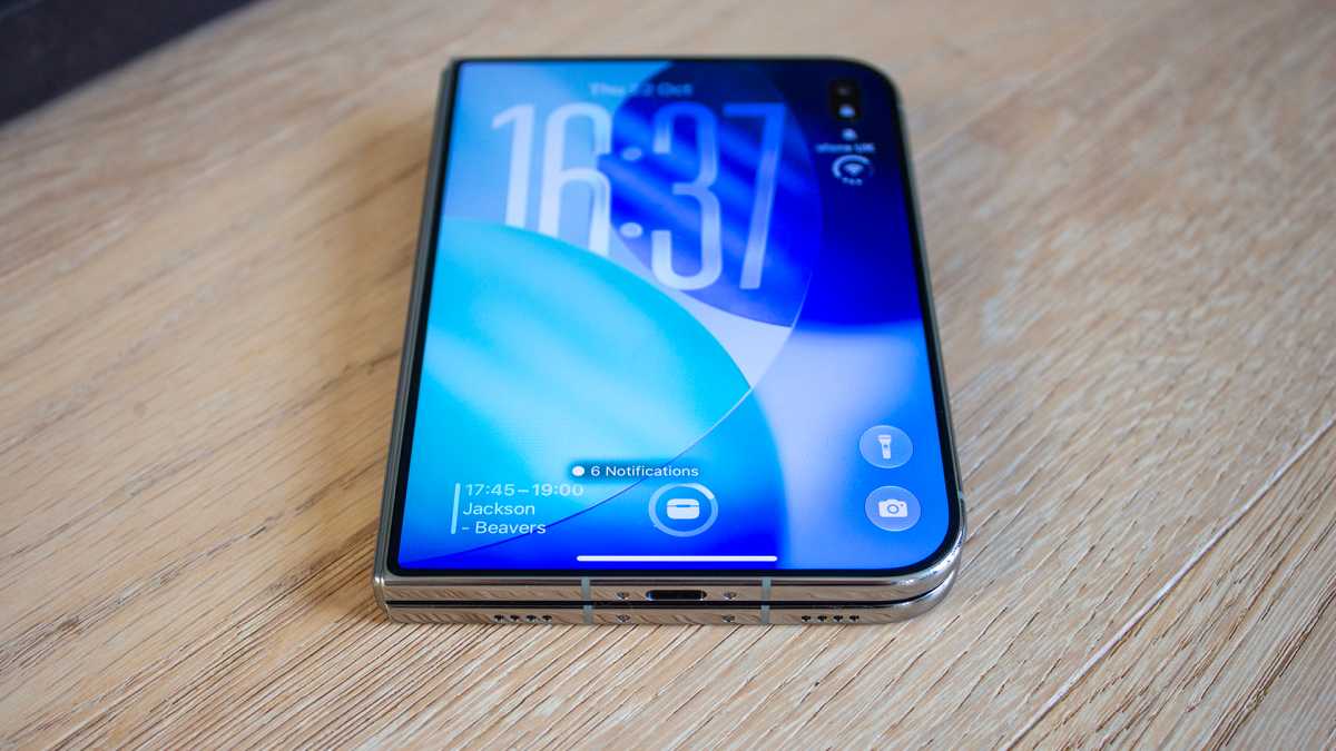 iPhone Duo closed on a table with Lock Screen illuminated