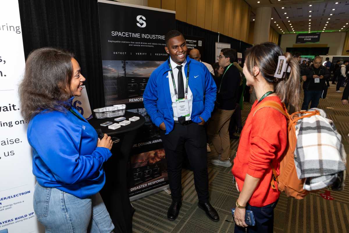Honorebel Walker, founder of SpaceTime Industries, chats with a Disrupt attendee.