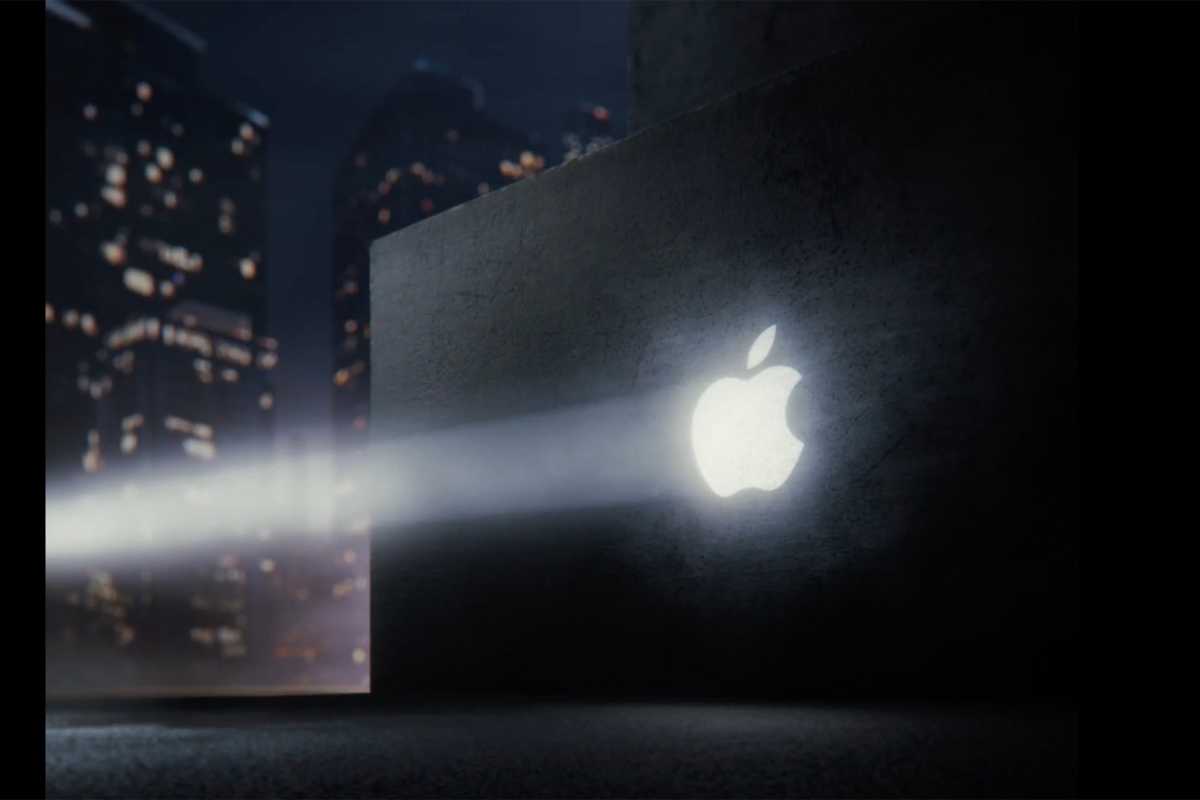 Image of an Apple logo illuminated onto a wall